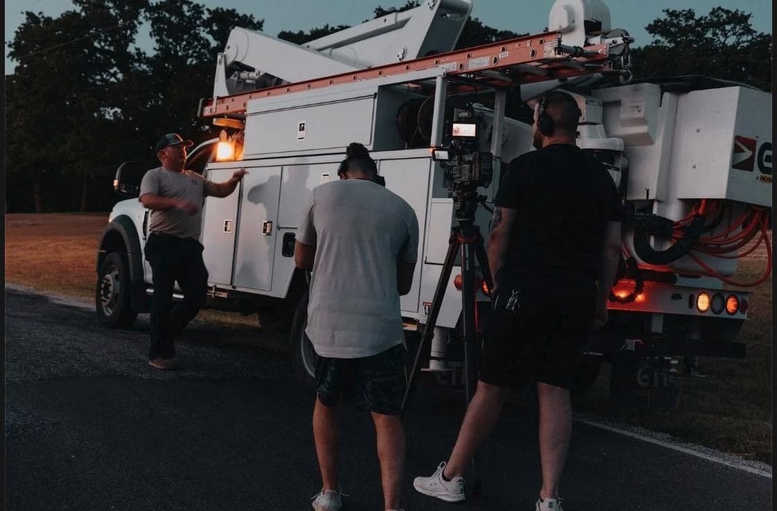 People's Electric Cooperative bucket truck and crew on location at dusk near Ada, Oklahoma