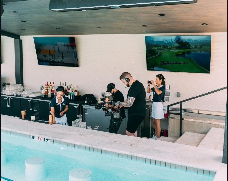 Video production crew filming at the poolside bar at Rose Creek Country Club